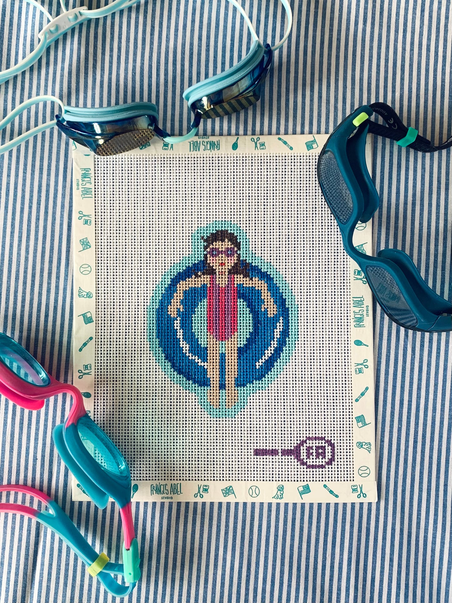 Pool Rats girl needlepoint canvas kit—retro swimmer in blue striped suit on aqua pool, 13-mesh DIY craft