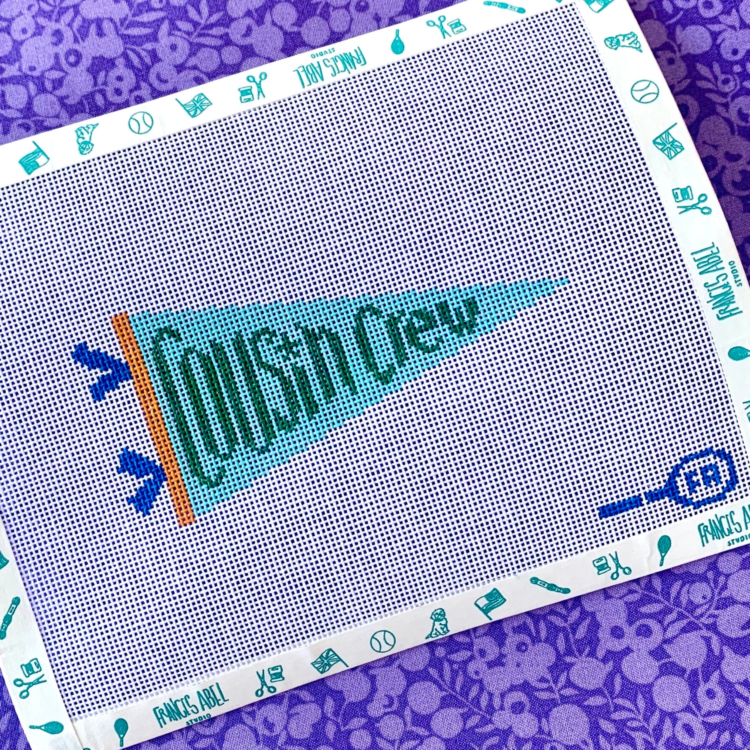 Cousin Crew pennant needlepoint canvas kit—turquoise pennant with teal “Cousin Crew” lettering and orange hoist, 4.25 × 2.25 in on 18-mesh DIY project