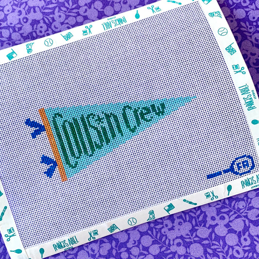 Cousin Crew pennant needlepoint canvas kit—turquoise pennant with teal “Cousin Crew” lettering and orange hoist, 4.25 × 2.25 in on 18-mesh DIY project