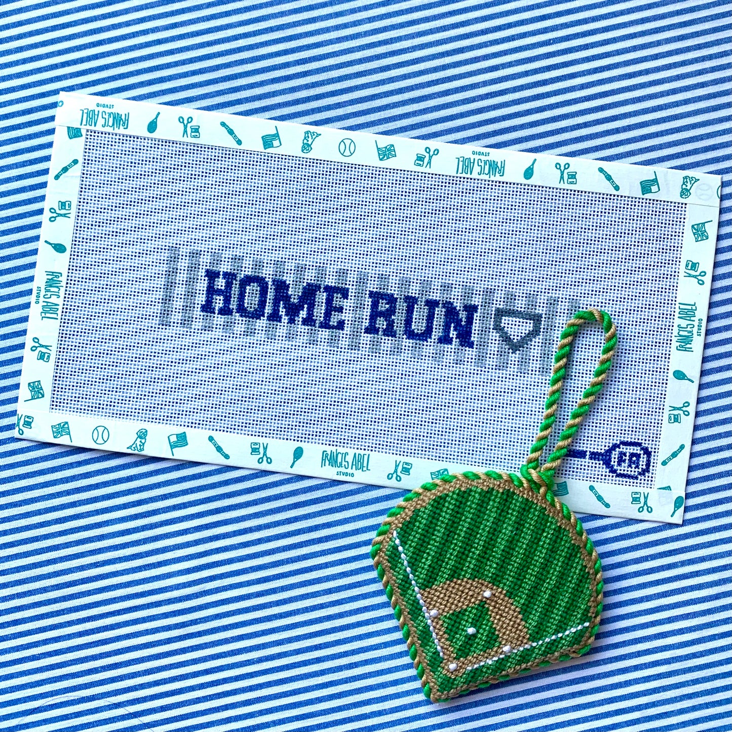 Home Run key-fob needlepoint canvas kit—navy “HOME RUN” text with home-plate icon, 6.5 × 1 in on 18-mesh, DIY baseball gift