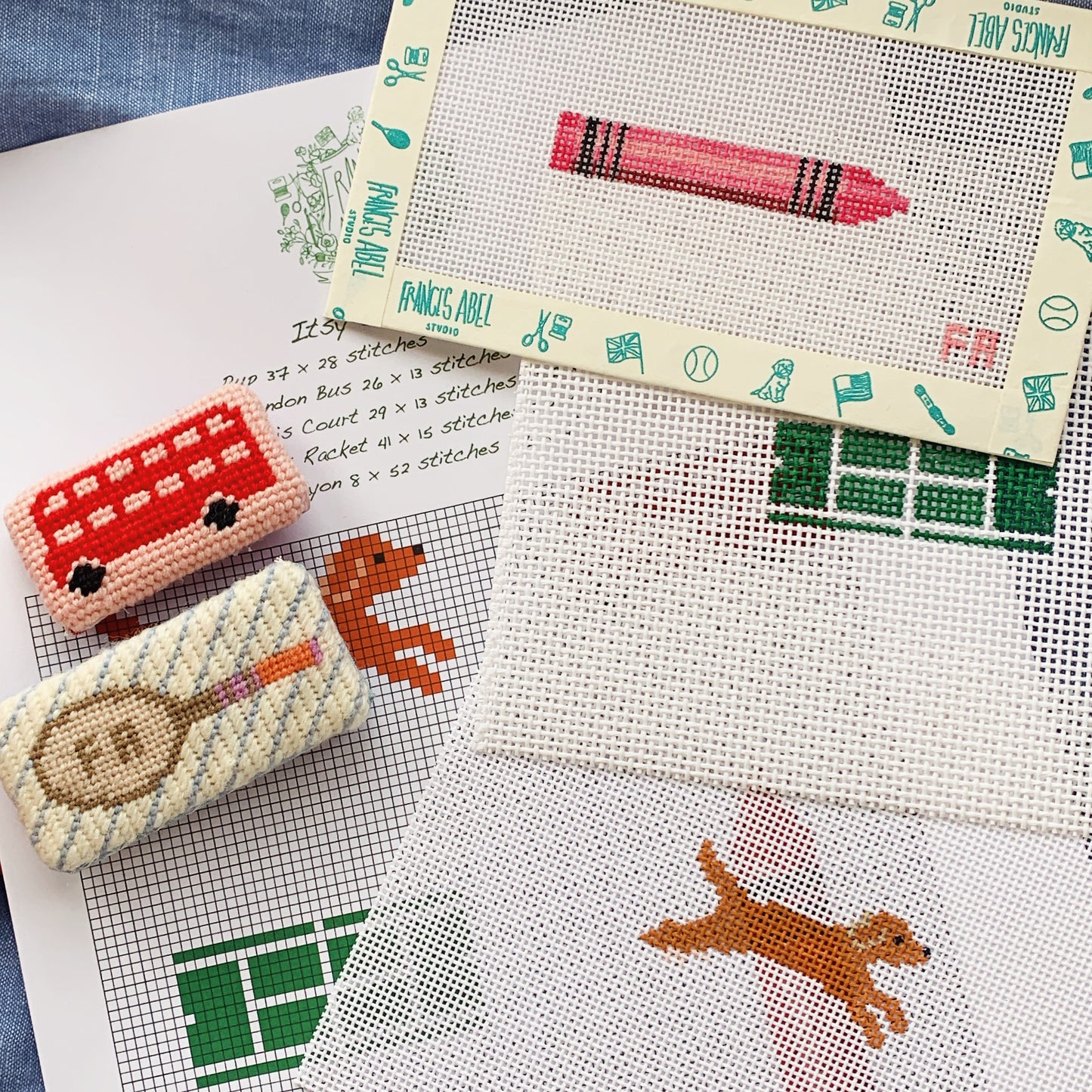 Itsy Bitsy Minis sampler PDF chart—grid of bus, tennis racket, dog silhouette, and tennis court motifs on 13-mesh canvas layout