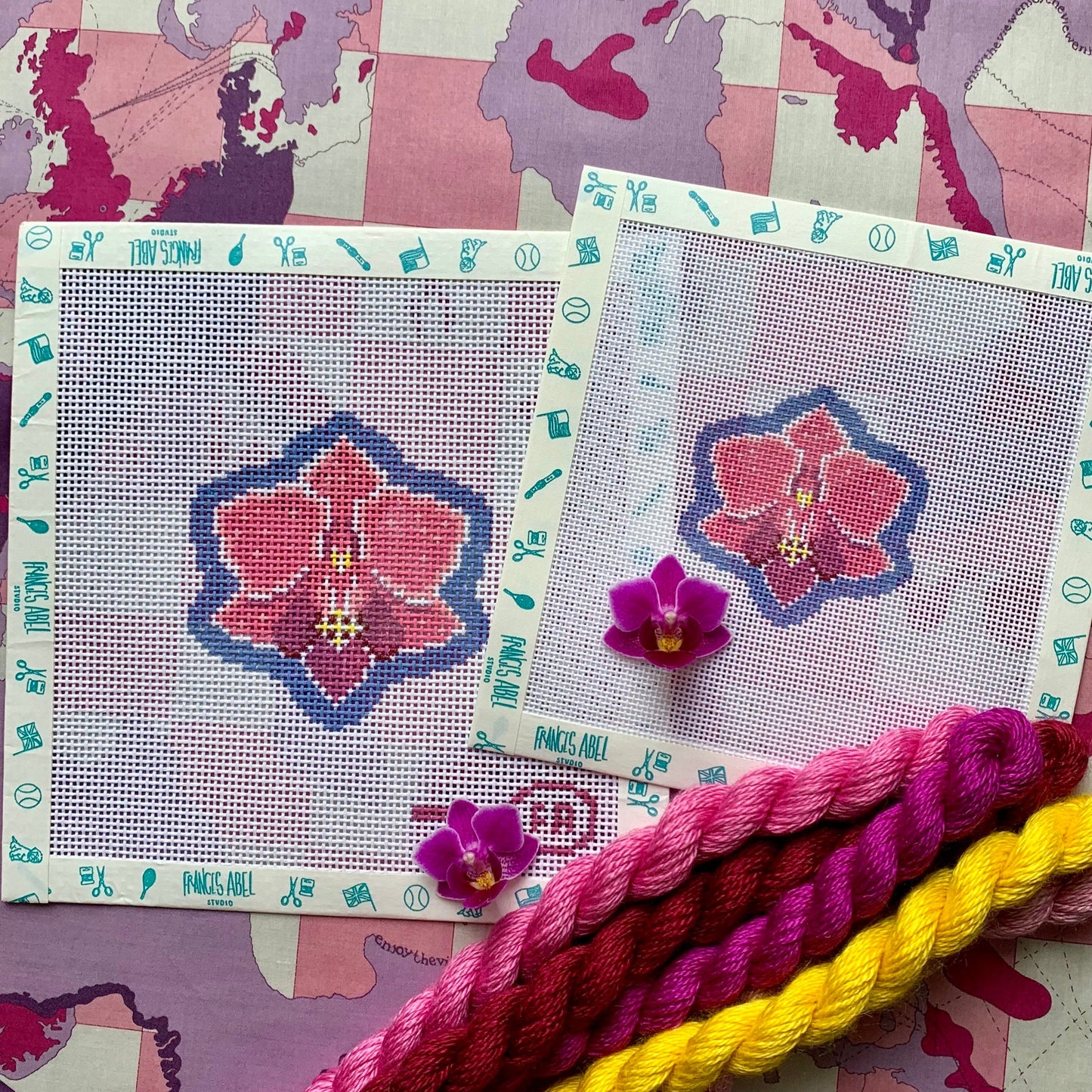 Mini orchid needlepoint canvas kit—pink orchid bloom on 18-mesh, 2.4 × 2.5 in, DIY floral project with magenta thread skeins