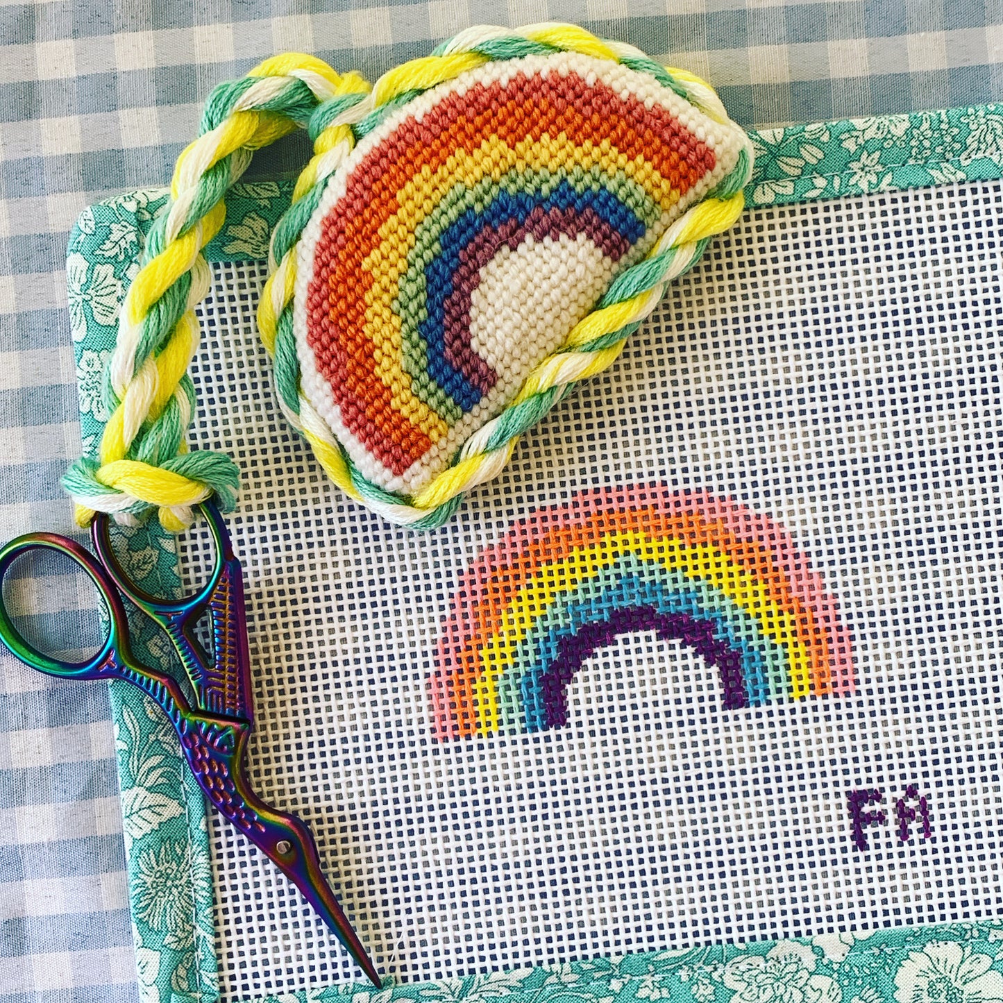 Mini rainbow needlepoint canvas with hand-painted pastel stripes in pink, orange, yellow, green, blue, and purple on white 13 mesh.