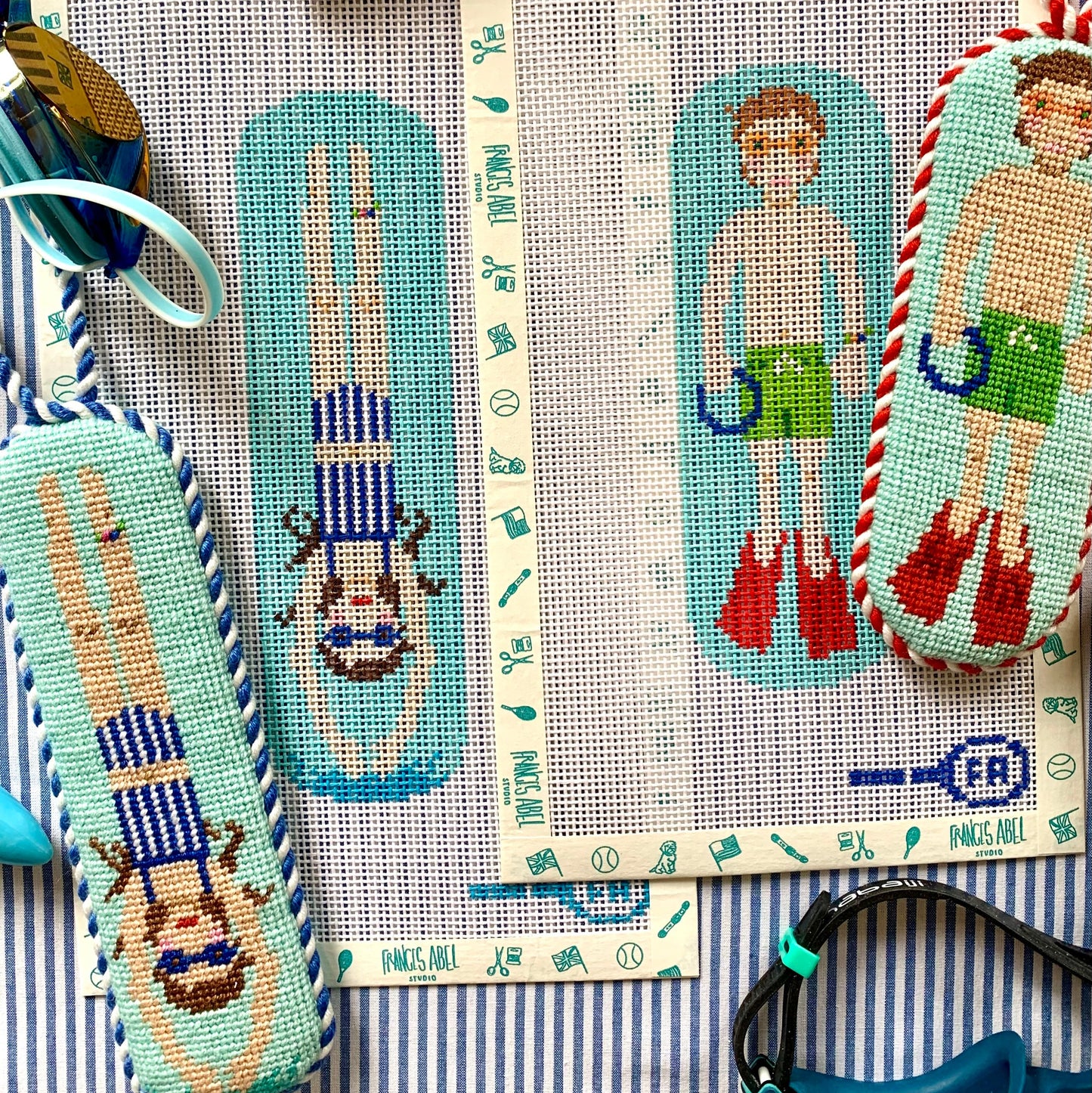 Pool Rats needlepoint canvases—retro girl and boy swimmers on aqua pool backgrounds, 13-mesh DIY summer duo kit