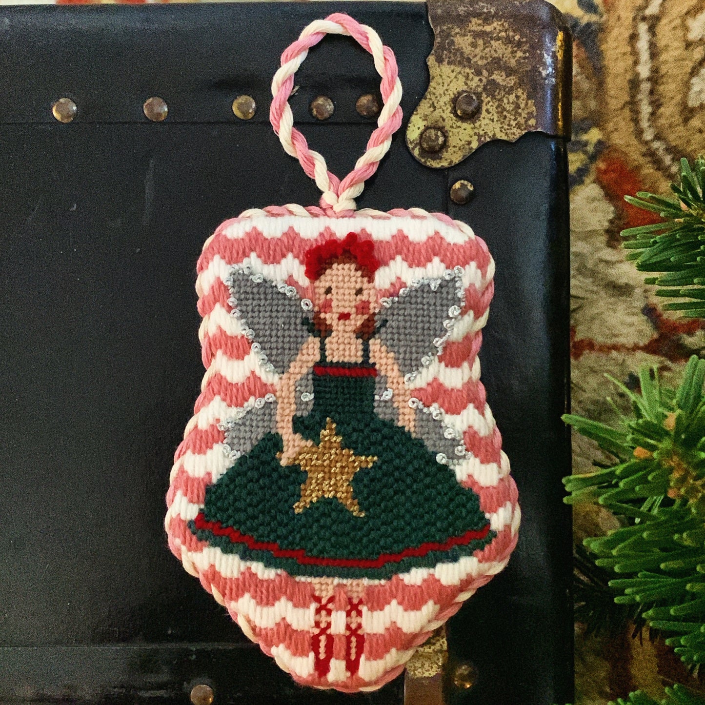  Christmas fairy needlepoint canvas featuring a ballerina-style fairy in a green dress holding a yellow star, with silver wings and a red headband, trimmed in aqua floral tape and surrounded by striped ribbon and jingle bells.