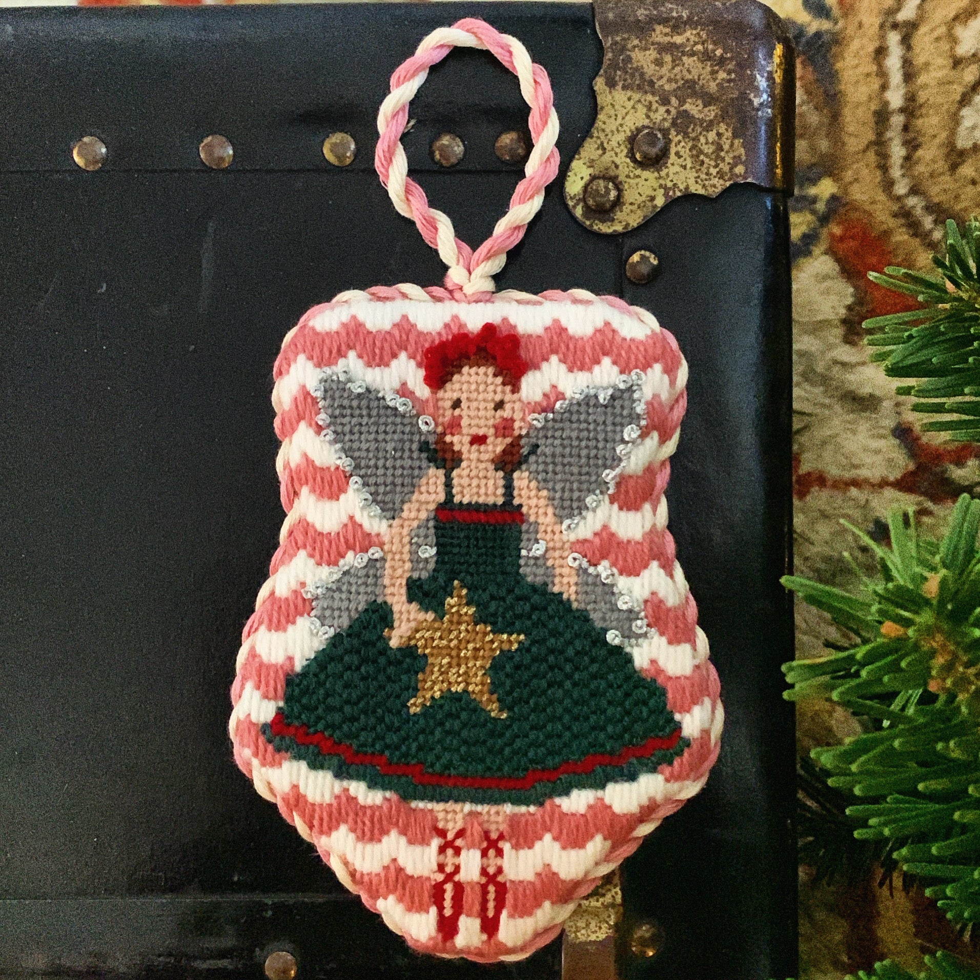  Christmas fairy needlepoint canvas featuring a ballerina-style fairy in a green dress holding a yellow star, with silver wings and a red headband, trimmed in aqua floral tape and surrounded by striped ribbon and jingle bells.