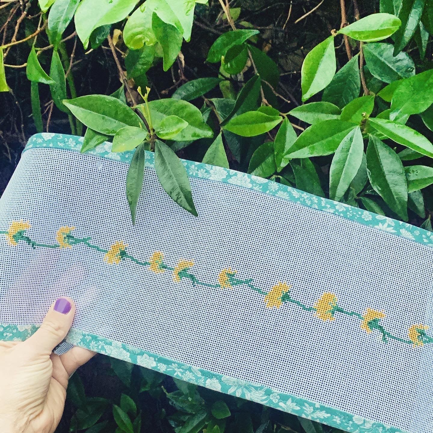 Dandelion Chain belt/hat band needlepoint canvas kit—repeat yellow dandelion blossoms linked by green stems printed on 14-HPI canvas strip, 37″ × 1¼″ DIY accessory project