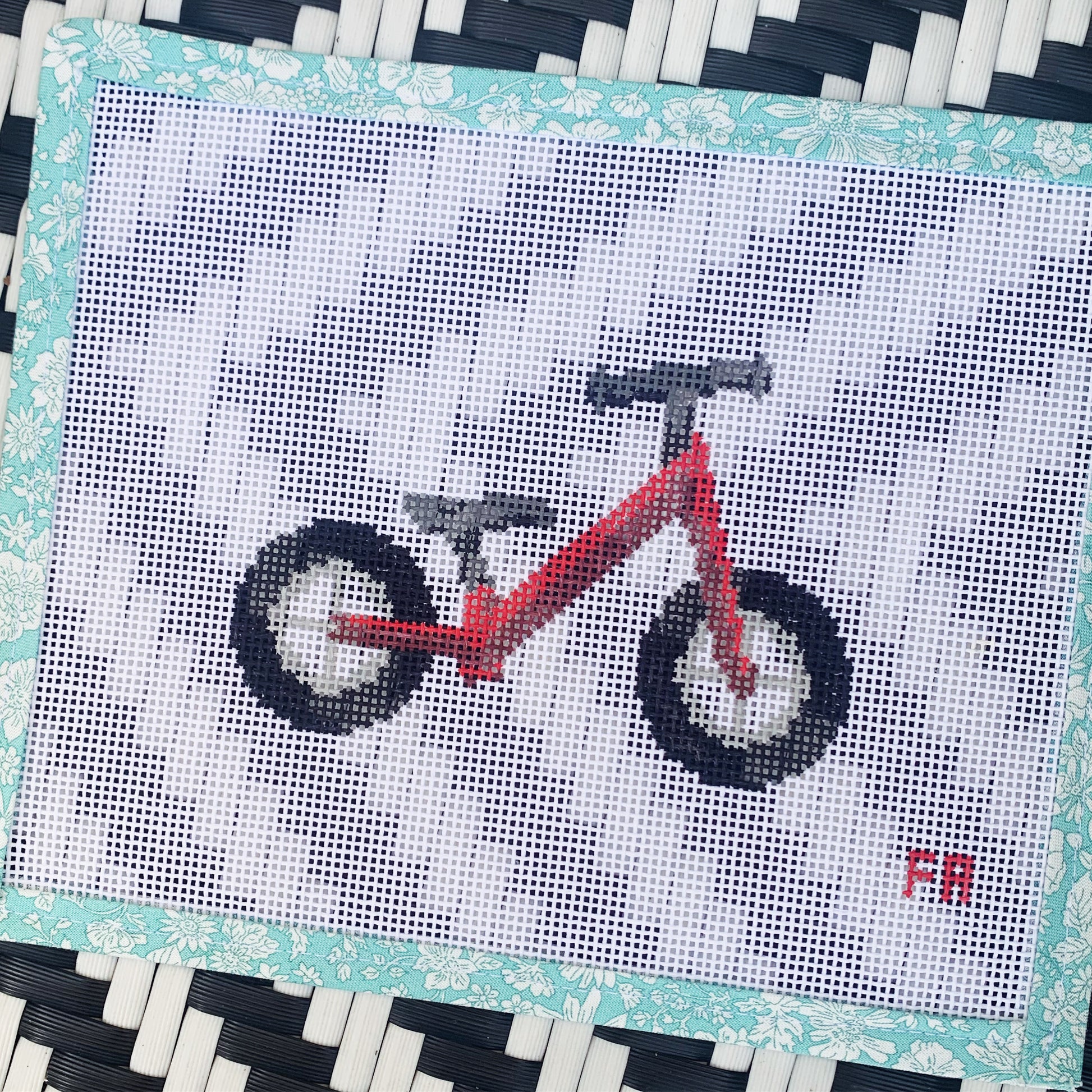 Red balance bike needlepoint canvas kit—stylized red toddler balance bike printed on natural 14-mesh canvas, 3¼ × 5″ DIY nursery décor project
