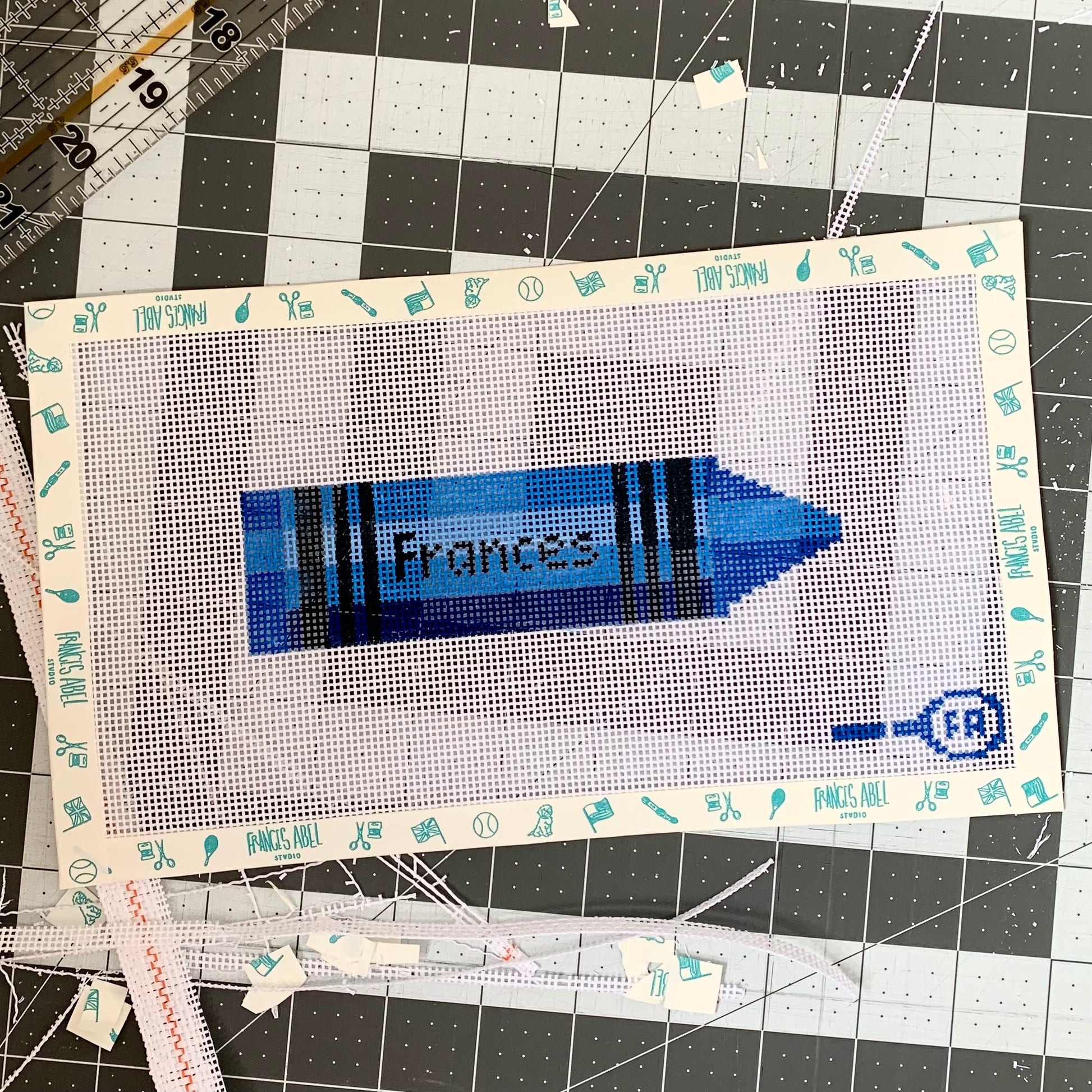  Custom crayon-shaped needlepoint canvas—red 13-mesh canvas printed with placeholder “NAME” in black block letters for DIY personalized décor