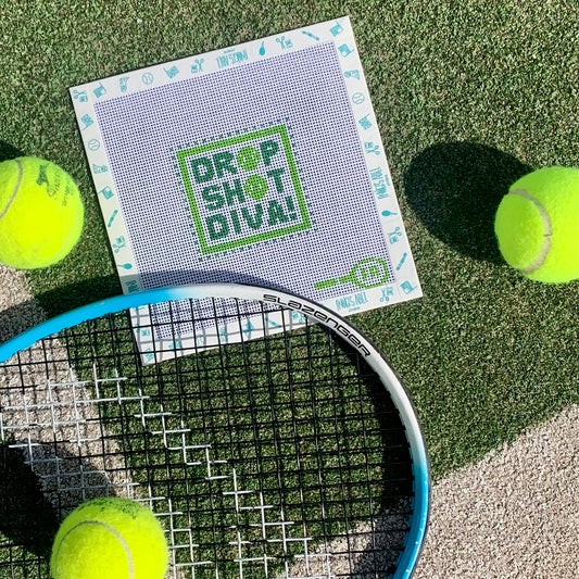 Drop Shot Diva needlepoint canvas kit—green block-letter “DROP SHOT DIVA” design on 3″ square 14-hpi canvas, styled flat on artificial turf with a tennis racket and three neon yellow tennis balls