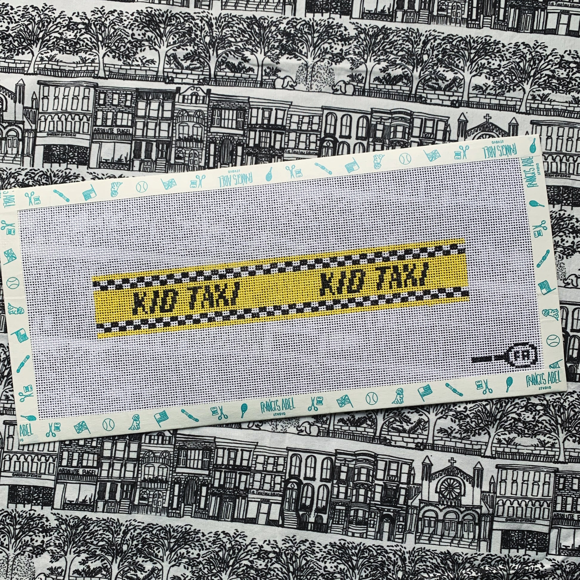 Kid Taxi key-fob needlepoint canvas—yellow checkered taxi stripe reading “KID TAXI,” 8.3 × 1.4″ on 13-mesh DIY project 