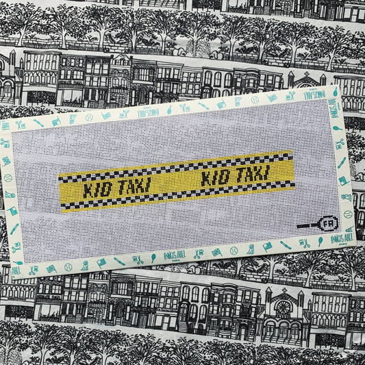 Kid Taxi key-fob needlepoint canvas—yellow checkered taxi stripe reading “KID TAXI,” 8.3 × 1.4″ on 13-mesh DIY project 