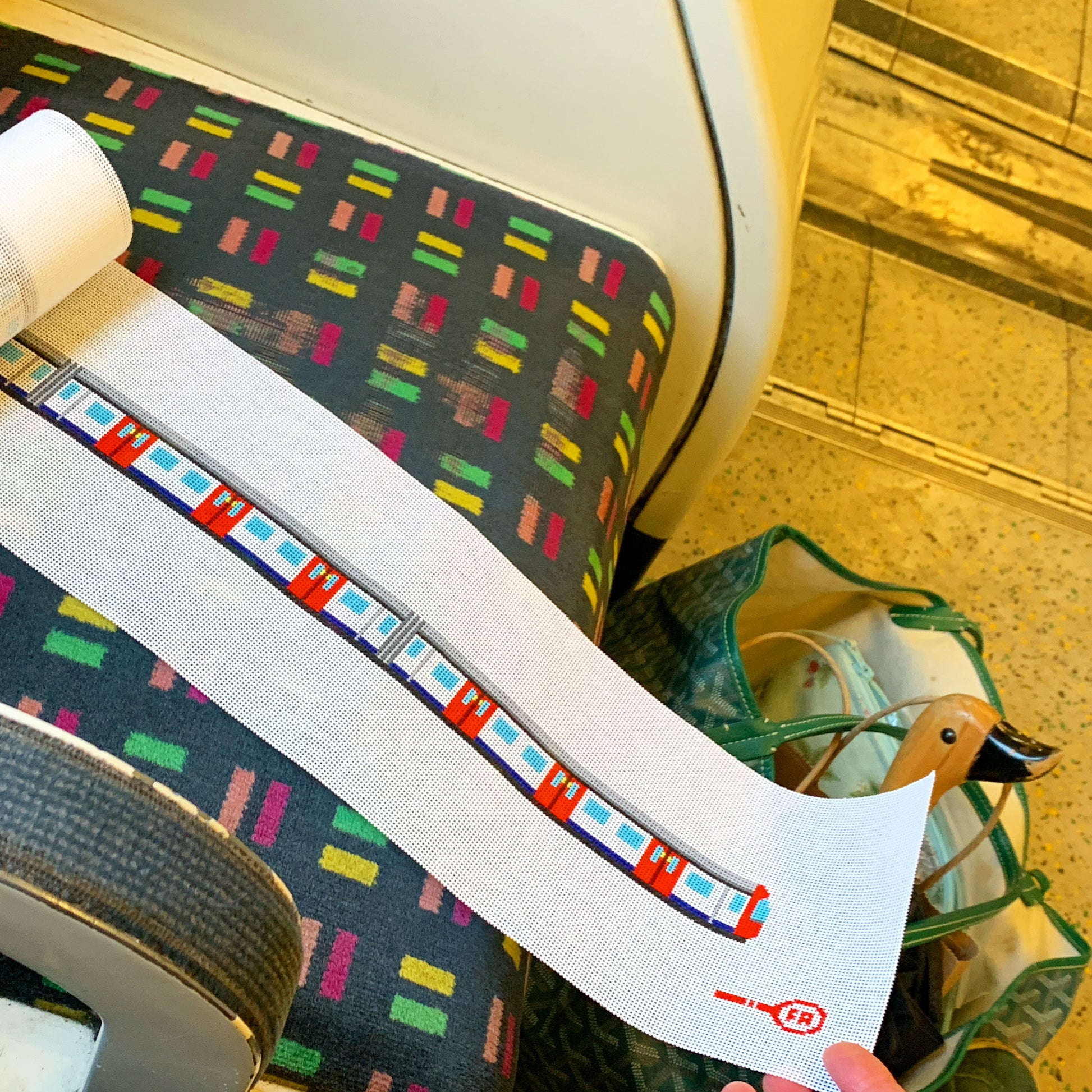 London Tube belt/hat band/bag strap needlepoint canvas—repeat Underground roundel and colored line segments printed on natural 18-mesh strip, 36″ × 1″ DIY accessory kit
