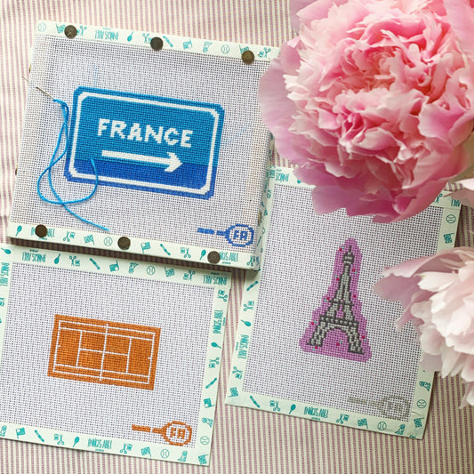 Mini clay tennis court needlepoint canvas kit—3⅛ × 2″ orange clay court with white boundary lines printed on natural 14-mesh canvas for DIY patch or scissors fob

