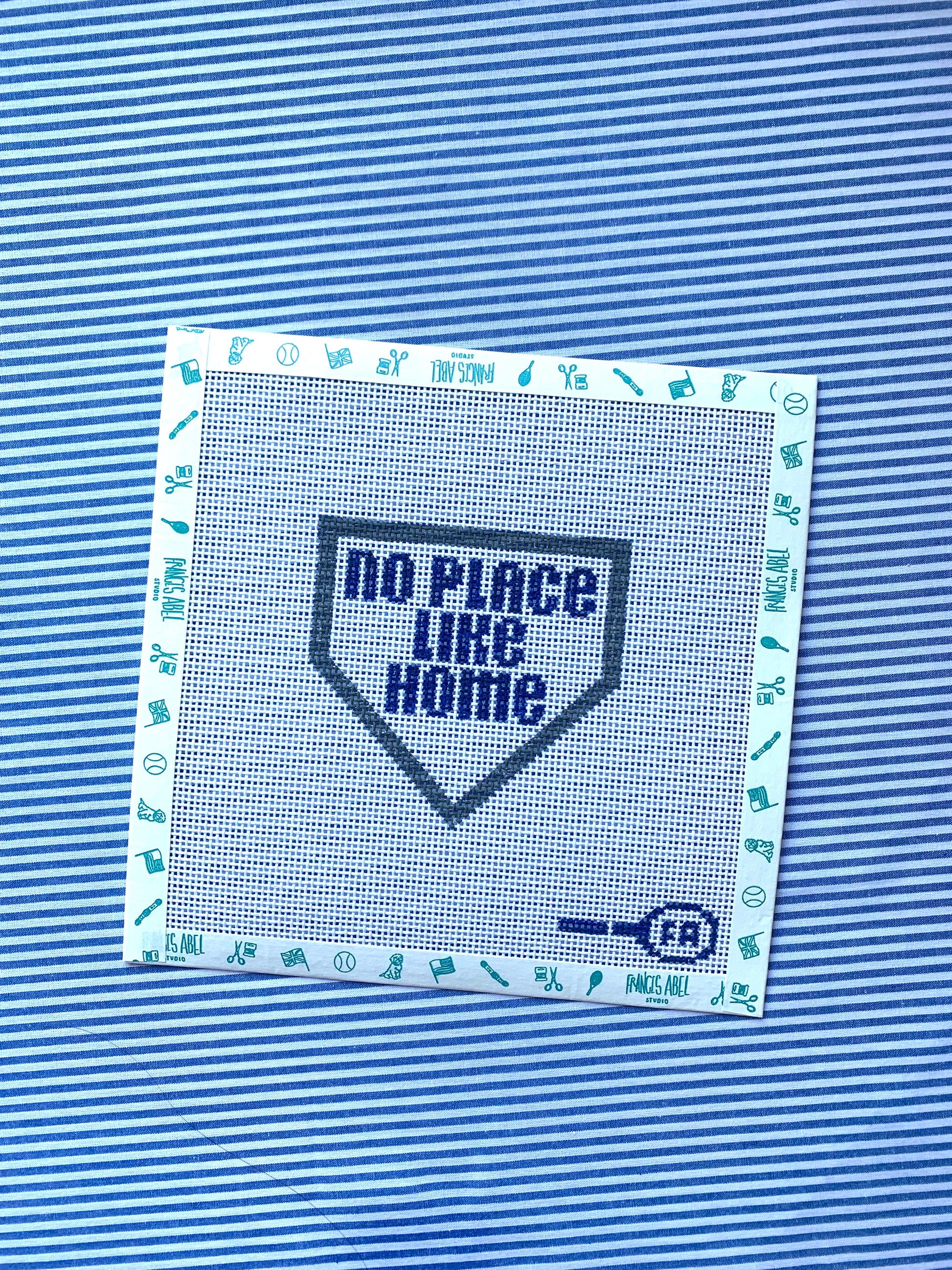 ‘No Place Like Home’ needlepoint canvas ornament—navy text inside baseball-home-plate shape, 4.2 × 4.5″ on 13-mesh DIY project