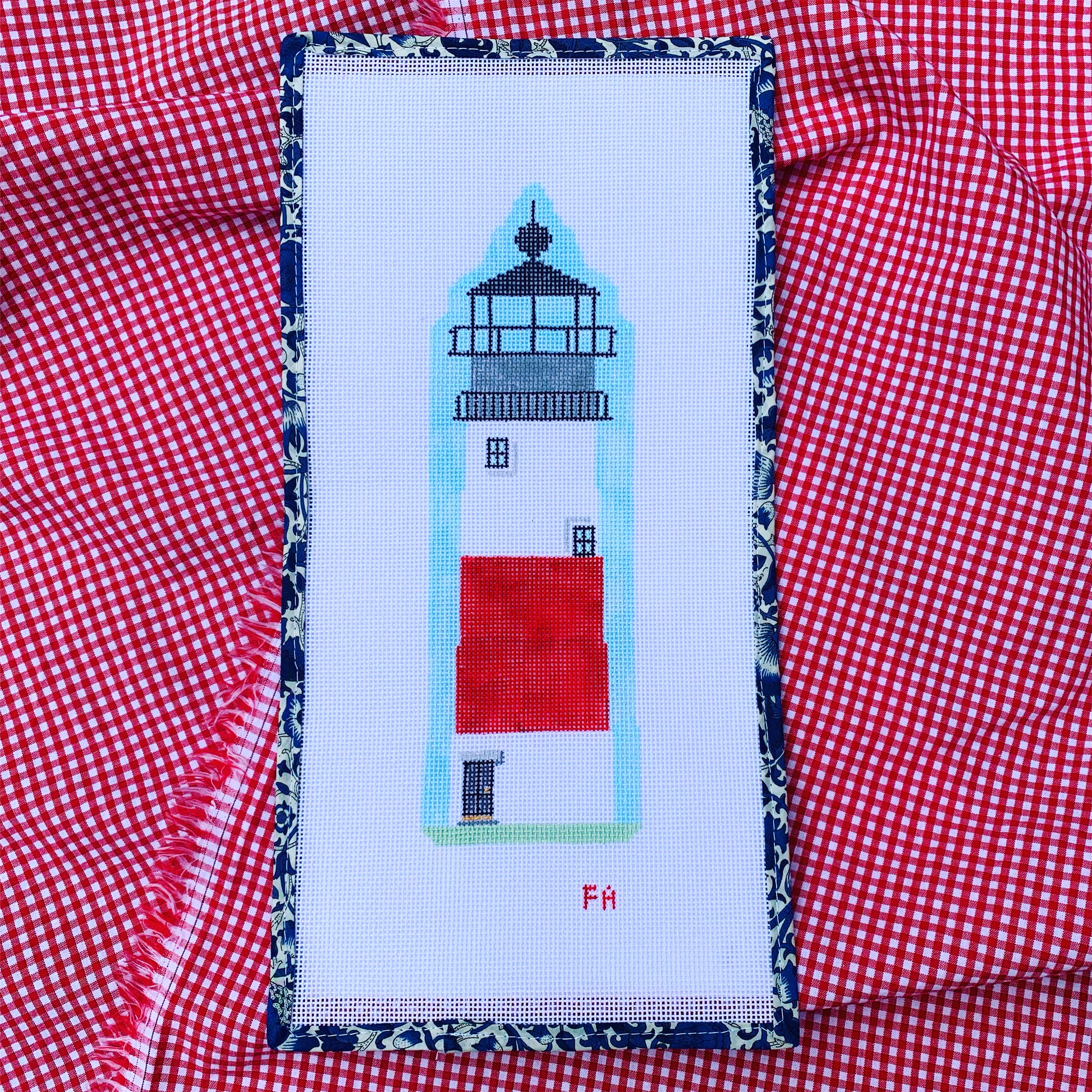 Sankaty Lighthouse needlepoint canvas featuring a bold red and white striped lighthouse with green grass and blue sky, hand-painted on 13 mesh.