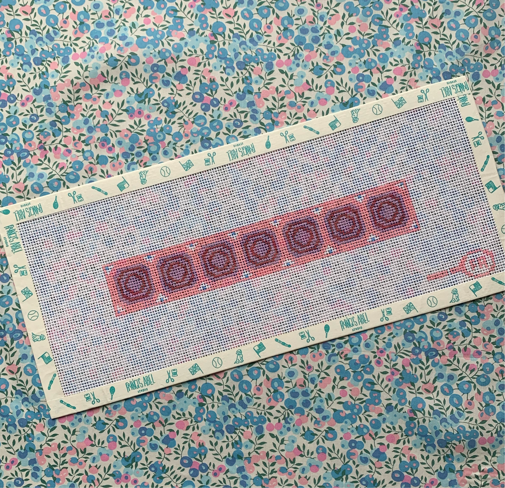 Union Station key-fob needlepoint canvas kit in pink—ceiling-inspired geometric pattern in rose, olive, and teal, 8¾ × 1½″ on 14-mesh DIY accessory